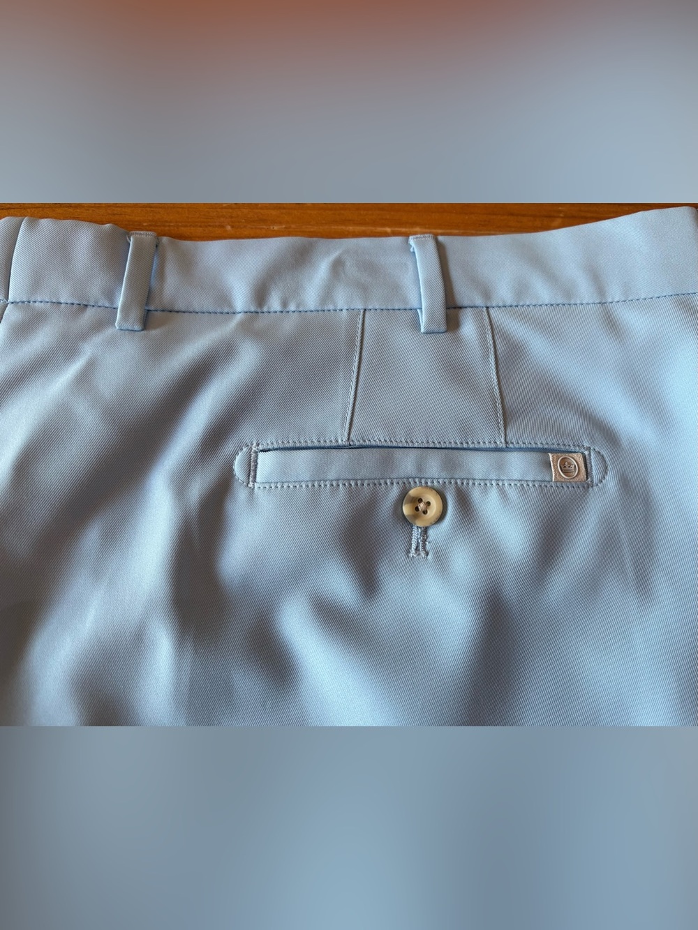 Peter Millar men’s golf shorts. Light blue with logo on pocket. Size: 42